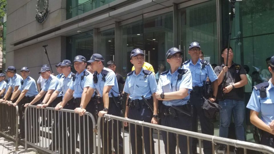 Police lined up outside of their headquarters in Wan Chai during a protest on Friday. Photo by Vicky Wong.
