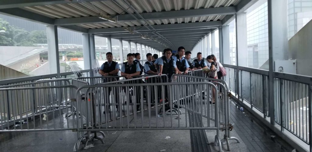 Police block a pedestrian bridge leading to the Legislative Council offices in Admiralty today. Photo by Vicky Wong.