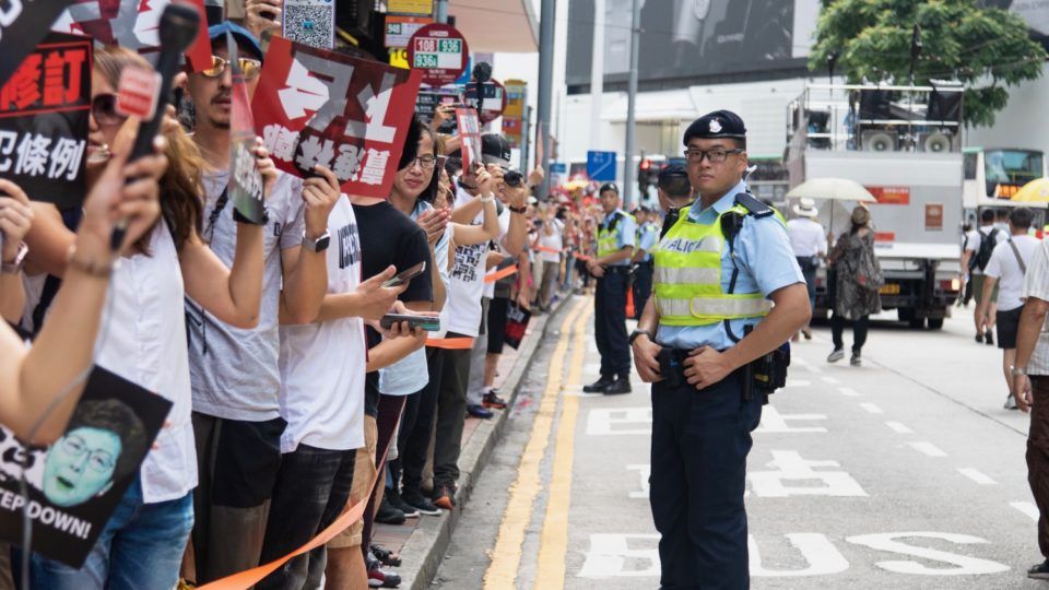 A policeman keeps order as tens of thousands of protesters wend their way through Hong Kong on June 9, 2019. Photo by Samantha Mei Topp.