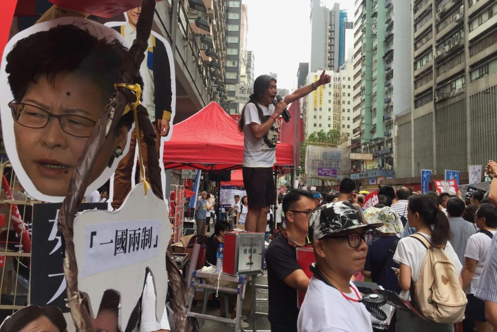 Pro-democracy activist Leung Kwok-hung, aka Long Hair, fires up demonstrators as hundreds of thousands of Hongkongers took the streets on Sunday to protest a controversial extradition bill. Photo by Stuart White.