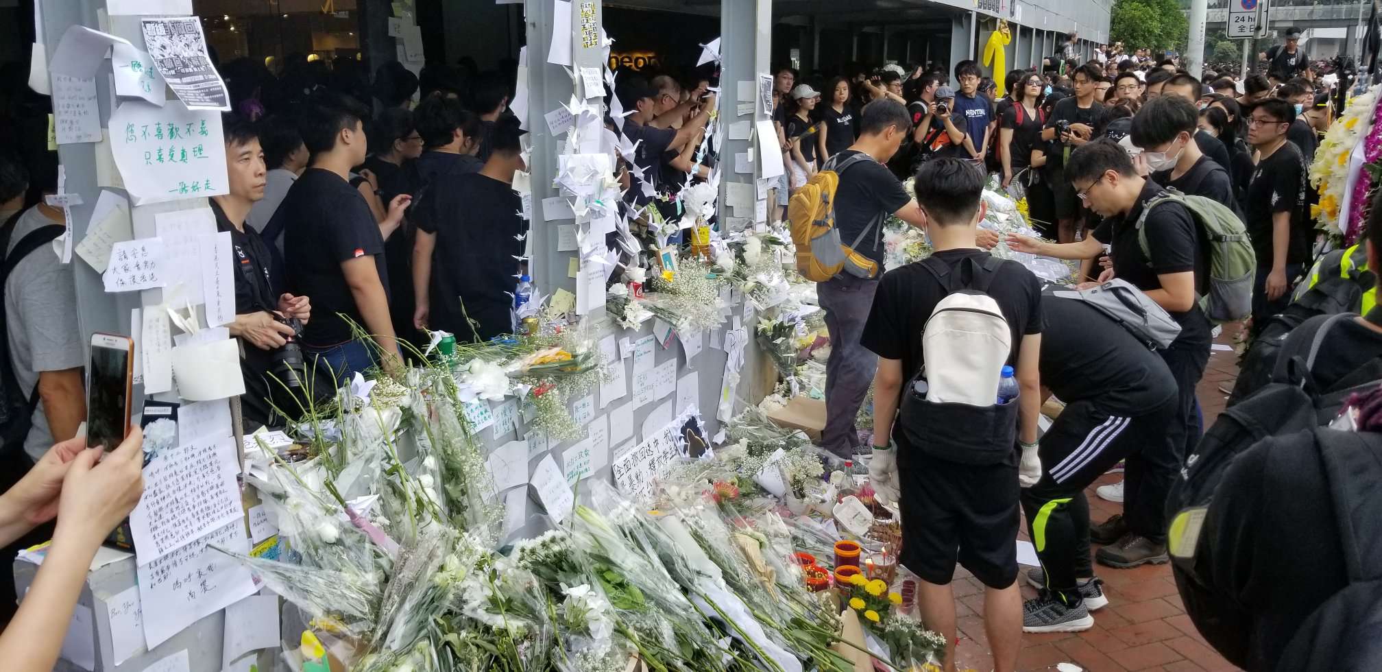 Anti-extradition protesters leave flowers at a memorial outside Hong Kong's Pacific Place mall, where a protester fell to his death on Saturday, June 15. Photo by Vicky Wong / Coconuts Hong Kong