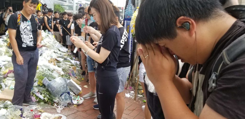 Anti-extradition protesters pay prayerful respects to a man who fell to his death on Saturday, June 15, while protesting the controversial legislation. Photo by Vicky Wong / Coconuts Hong Kong