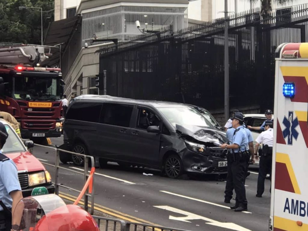 Police investigate the scene after a truck rammed into the back of a taxi -- bumping into a private car on the way -- on Garden Road this afternoon. Photo via Facebook/ Ngo Wk.