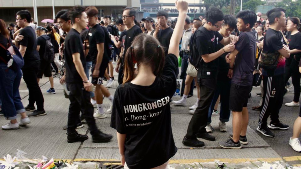 A girl wearing a shirt reading “Hongkonger” raises her fist at an anti-extradition bill march on June 16. Photo by Vicky Wong.