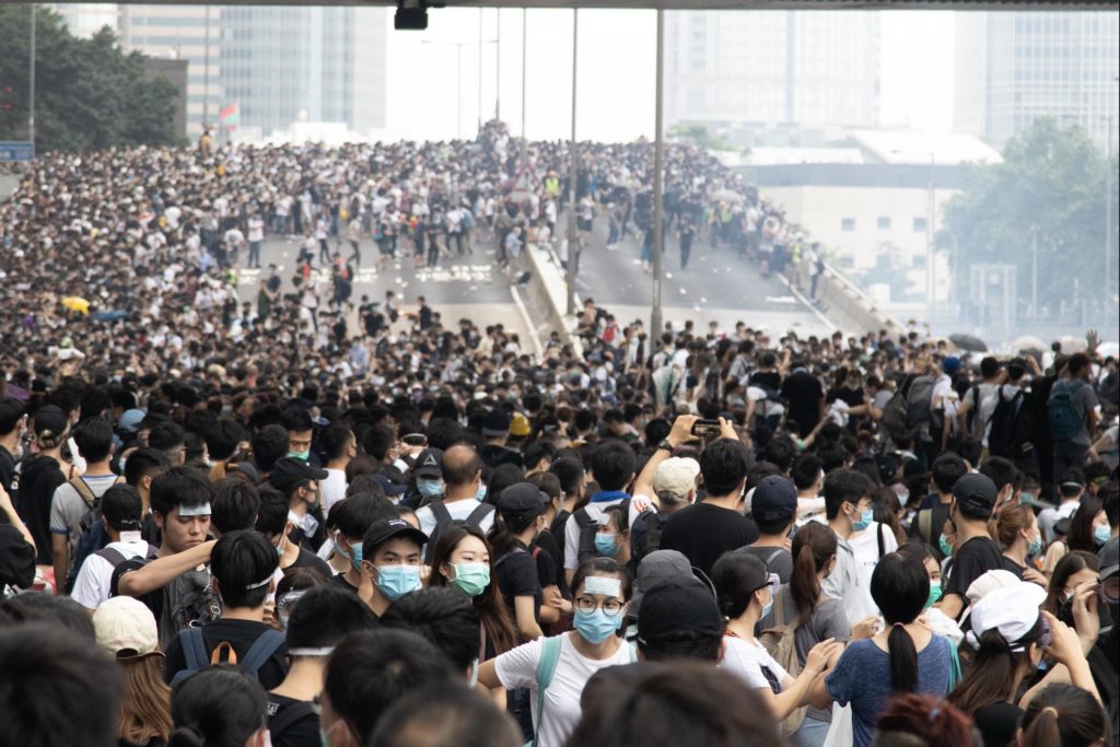 Protesters fleeing from clouds of tear gas during a demonstration against a controversial extradition bill. Photo by Samantha Mei Topp.