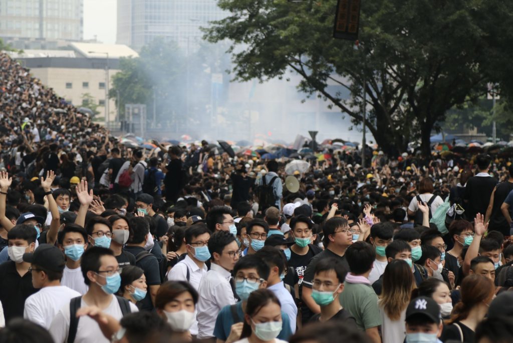 Protesters fleeing from clouds of tear gas during a demonstration against a controversial extradition bill. Photo by Samantha Mei Topp.