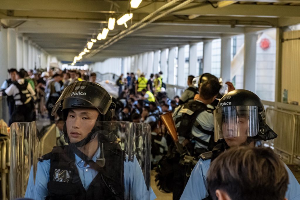 Police in riot gear during an extradition bill protest. Photo by Tomas Wiik.