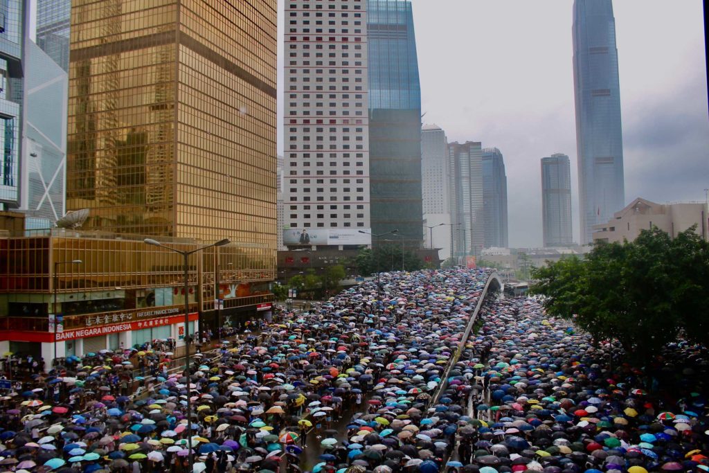 Umbrellas out as it starts to rain during an extradition bill protest. Photo by Vicky Wong.