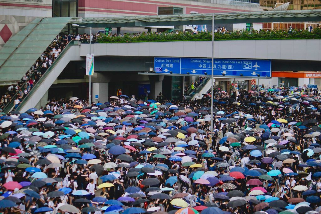 Umbrellas out as it starts to rain during an extradition bill protest. Photo by Vicky Wong.