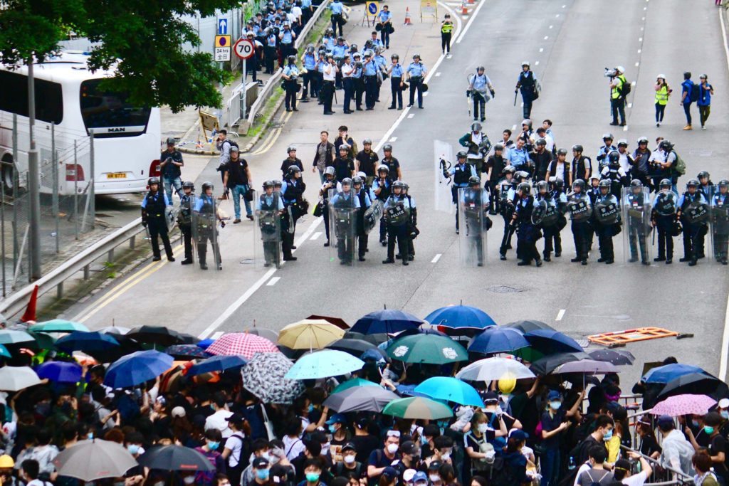 Police and protesters facing off during an extradition bill protest. Photo by Vicky Wong.