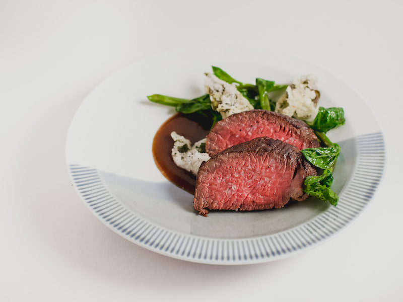 Main: Chipotle-Berry Glazed Wagyu Chuck Tender, Vegetable Jus & Spiced Malabar Spinach. Photo: Kausmo