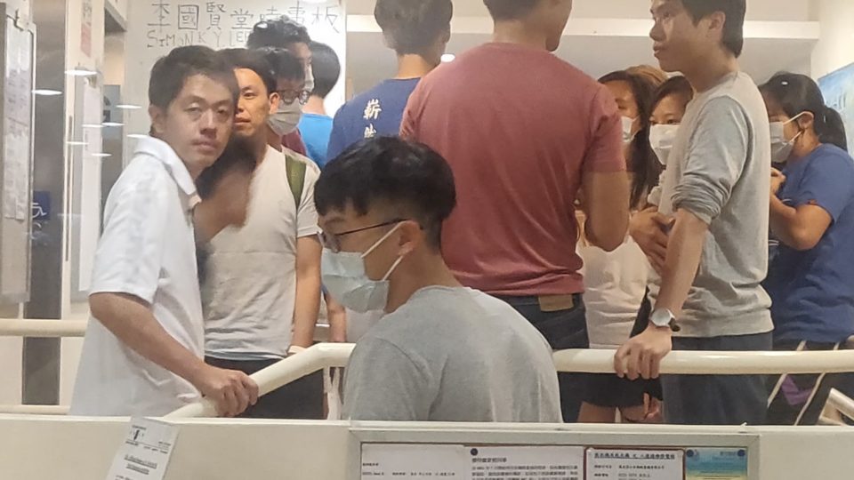 Lawmakers Ted Hui (far left) and Roy Kwong (far right) inside the lobby of the Simon K.Y. Lee Hall at the University of Hong Kong, following reports that police had a search warrant for the dorm, Photo via Facebook/Campus TV.