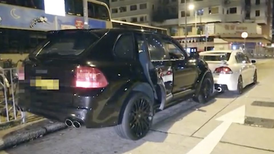 A black four-wheel drive Porsche crashes into the back of a stationary car after the driver led cops on a high-speed chase through Yuen Long. Screengrab via Apple Daily video.