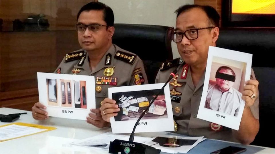 Indonesian police personnel show photographs of leader Para Wijayanto and various seized items, at a press conference in Jakarta on July 1, 2019, as Wijayanto was detained by counter-terrorism police with his wife on at a hotel in Bekasi, a city on the outskirts of the capital Jakarta. – Indonesian police said on July 1 they had arrested the leader of Al Qaeda-linked extremist network Jemaah Islamiah, which carried out the 2002 Bali bombings that killed more than 200 people. (Photo by STR / AFP)