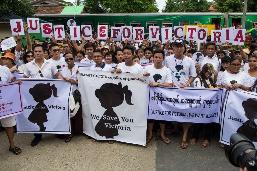 Protesters hold signs during the demonstration demanding justice for a two-year-old who was raped and given the pseudonym “Victoria” in front of the Central Investigation Department (CID) in Yangon on July 6, 2019. – Seven nurseries in Myanmar’s capital remained closed as police charged a suspect for allegedly raping a two-year-old, a case that has horrified a country where experts say assaults on children are widespread. (Photo by Sai Aung MAIN / AFP)