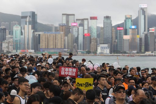 Protesters gather to take part in a march to the West Kowloon railway station, where high-speed trains depart for the Chinese mainland, during a demonstration against a proposed extradition bill in Hong Kong on July 7, 2019. – Hong Kong has been rocked by a month of huge peaceful protests as well as a series of separate violent youth-led confrontations sparked by a proposed law that would have allowed extraditions to mainland China. (Photo by Vivek PRAKASH / AFP)