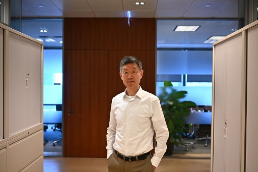 In this photo taken on July 12, 2019, Weijian Shan, chairman and CEO of private equity firm PAG Group and the author of ‘Out of the Gobi: My Story of China and America’, poses during an interview with AFP in Hong Kong. – Exiled to the Gobi Desert at the age of 15, Weijian Shan’s days were marked by gnawing hunger and back-breaking forced labour. But his sense of hope was kept alive by an unlikely source — insecticide manuals. (Photo by Anthony WALLACE / AFP) / TO GO WITH AFP STORY: Hong Kong-China-US-history-finance-politics, INTERVIEW by Ammu KANNAMPILLY