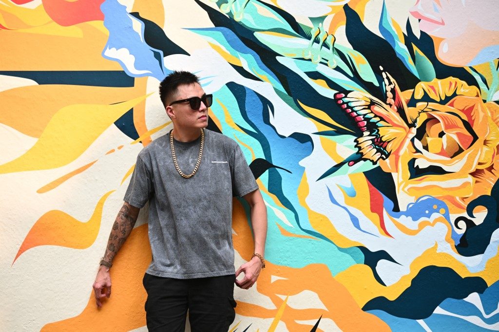 This photo taken on July 18, 2019 shows Singaporean rap artist Joshua Su posing during an interview with AFP in Hong Kong. - When Singaporean rapper Joshua Su came out to his parents, he decided to use an unconventional method -- through a new track where he raps: "G-A-Y-B-O-Y OK". (Photo by Anthony WALLACE / AFP)