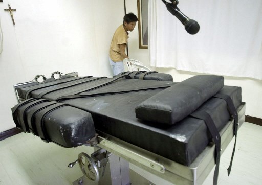 An inmate of the philippine national prison prepares the lethal injection chamber at the National Penitentiary in suburban Muntinlupa on January 9, 2004. <i> Photo by Joel Nito/AFP. </i>
