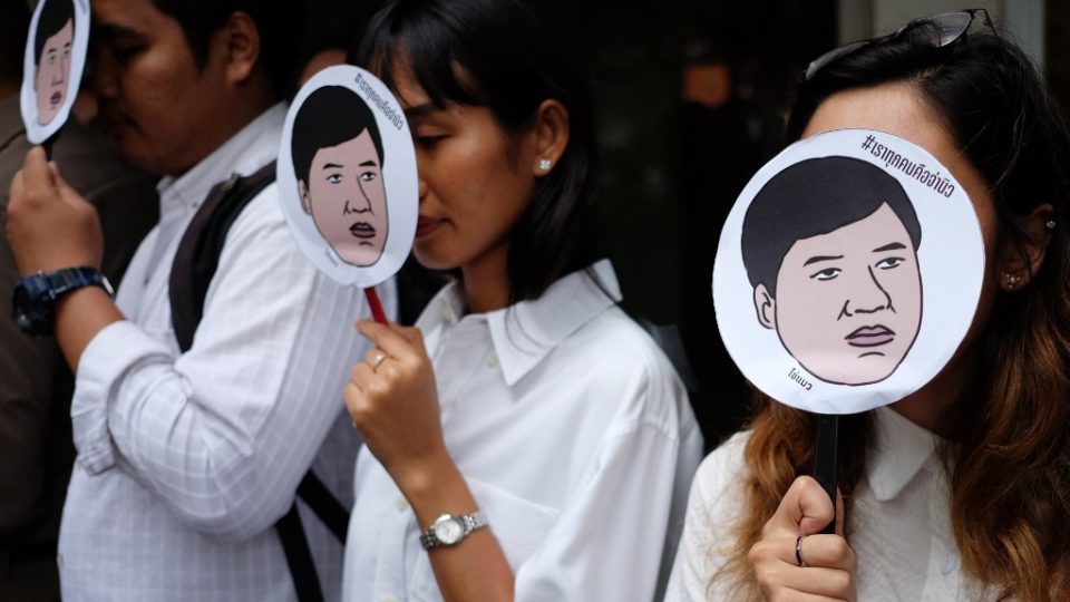 Amnesty International activists hold masks with an image of Sirawith ‘Ja New’ Seritiwat, who was beaten by unknown assailants, reading ‘We are all Ja New’ at a Wednesday protest in Bangkok. Photo: Candida Ng / AFP
