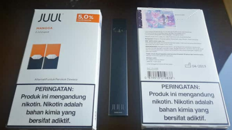 Official Juul pod packs and a Juul device sold in Indonesia.