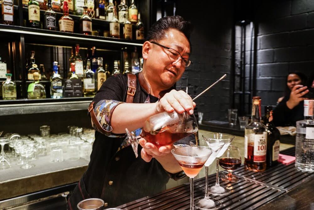 Hidetsugo Ueno, co-founder of Find the Locker Room, pours his signature drink. Photo: Coconuts Media