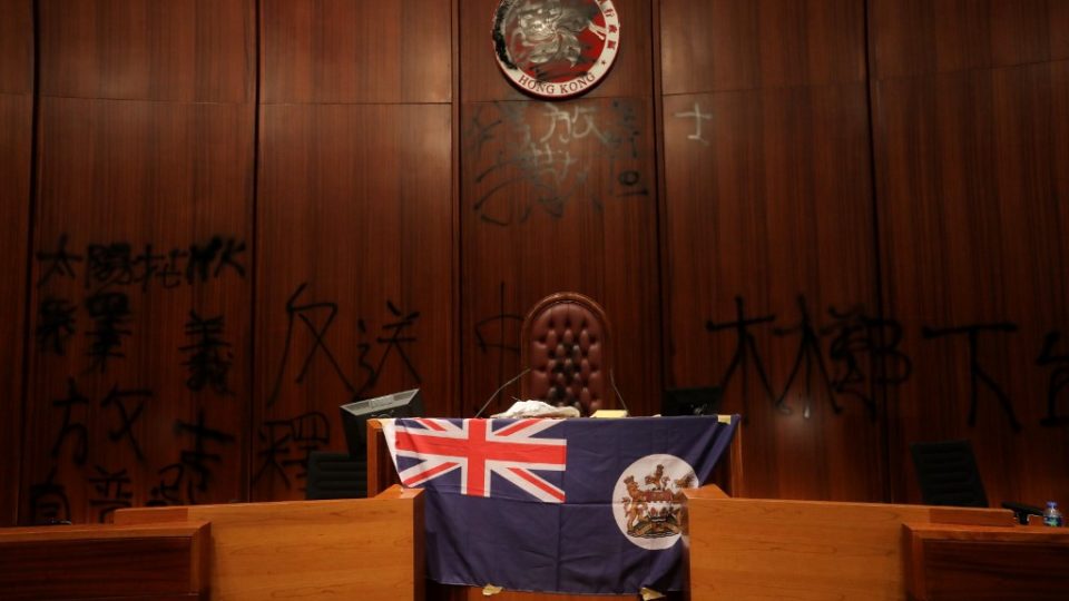 A British colonial-era flag hangs on a podium in Hong Kong’s LegCo after protesters stormed the building last night. Photo via AFP.