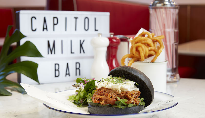 Stamford burger with charcoal brioche buns. Photo: Capitol Milk Bar