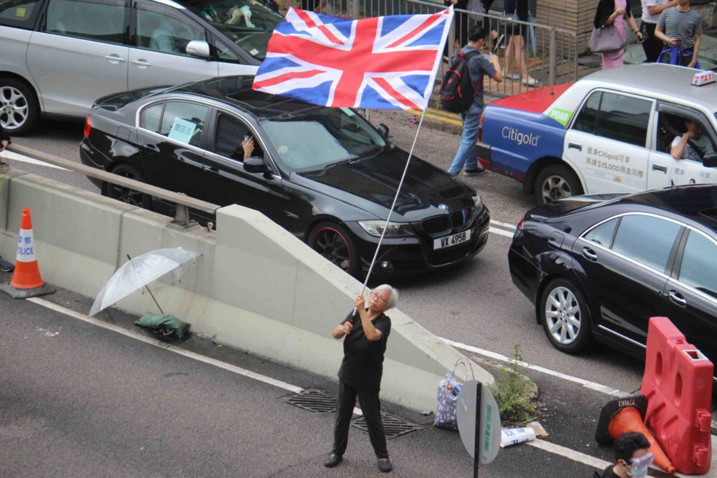 A protester waves the British flag at a demonstration in Hong Kong on June 12. Photo by Vicky Wong.