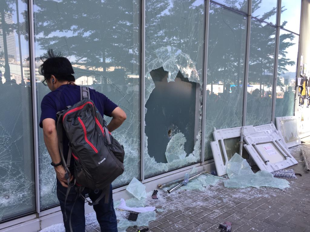 A window smashed by protesters next to the members' entrance of the LegCo yesterday. Photo by Stuart White.