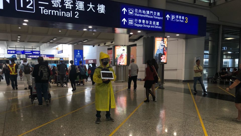 A protester wears a yellow rain jacket at Hong Kong International Airport in July in reference to a fellow protester who died in an apparent suicide the month before. Photo by Iris To.