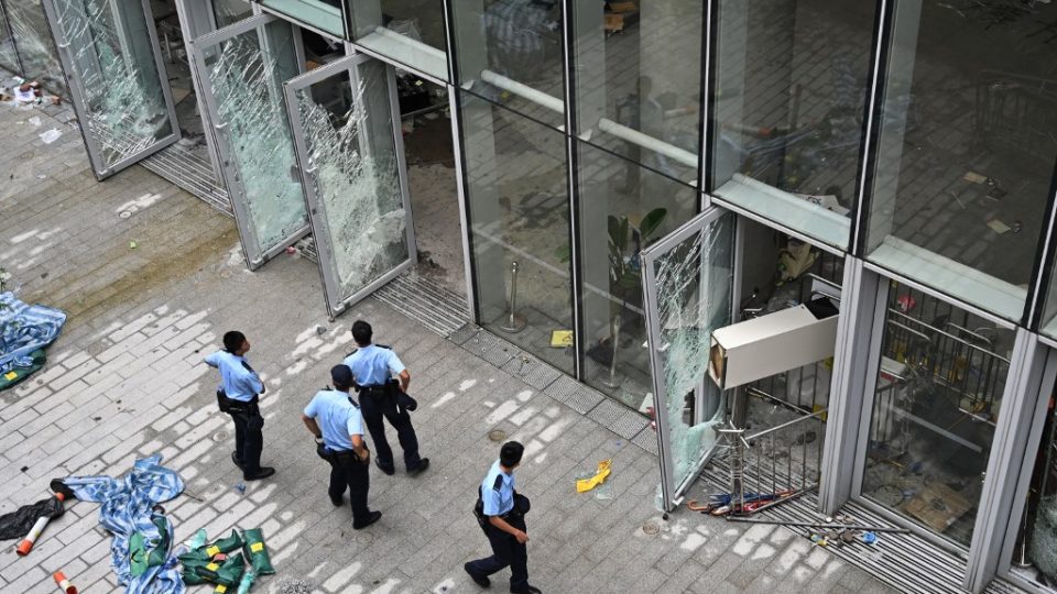Police stand outside the Legislative Council building in Hong Kong on July 2, a day after protesters broke into the building. Photo via AFP.
