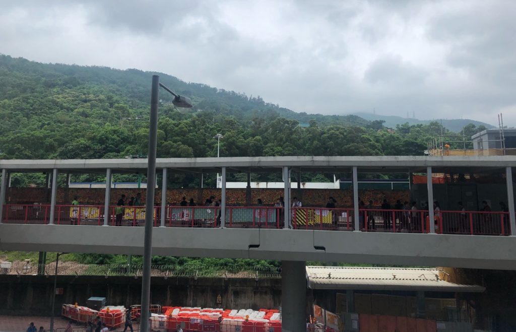 A 'Lennon Wall' stretches the length of a footbridge in Tsuen Wan. Photo by Iris To.