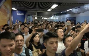 Passengers waiting on the platform of Admiralty MTR after protesters stage a guerrilla protest. Screengrab via Facebook video/RTHK.