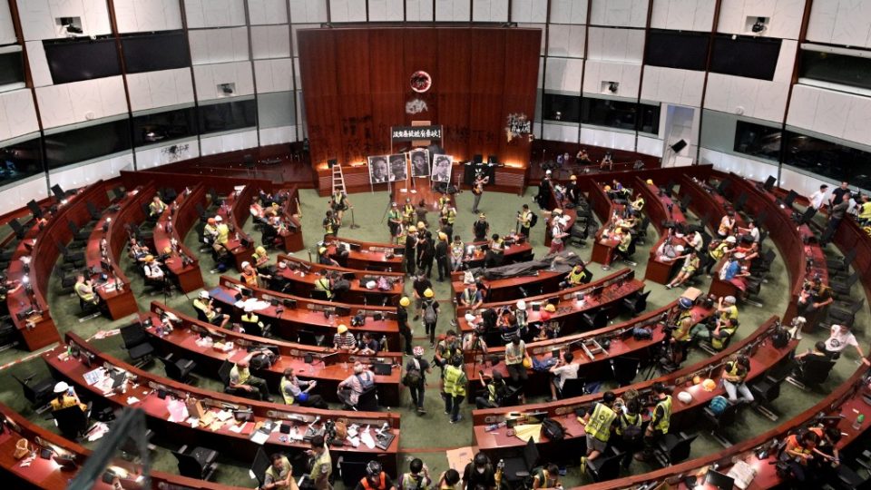 Protesters and members of the media are seen in the Hong Kong parliament chambers after protesters broke into the building on July 1. Photo via AFP.
