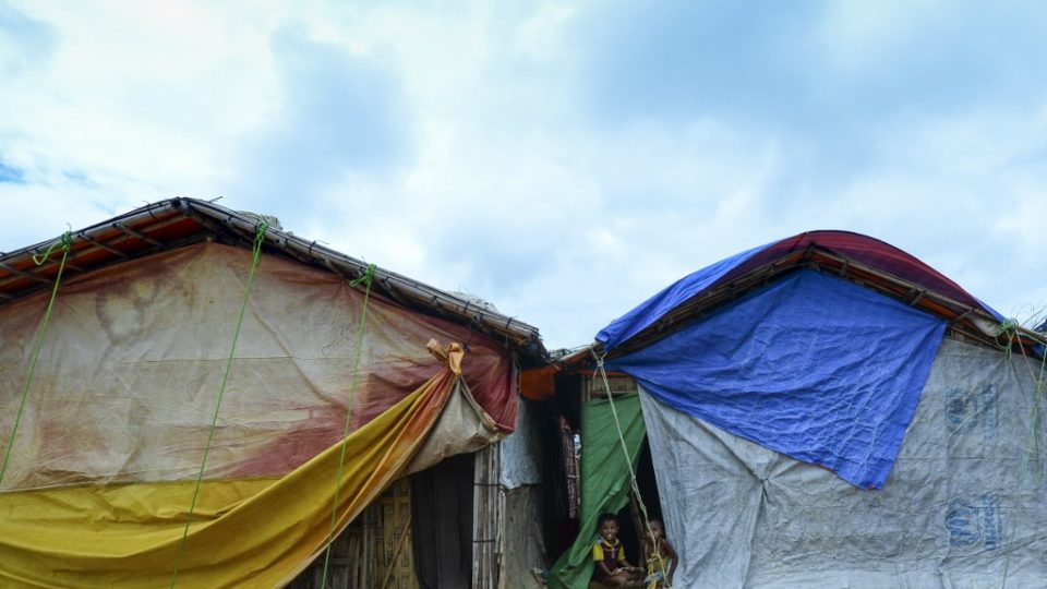 Rohingya children play in front of their makeshift home at Kutupalong refugee camp in Ukhia on July 24, 2019. (Photo by Munir Uz Zaman / AFP)