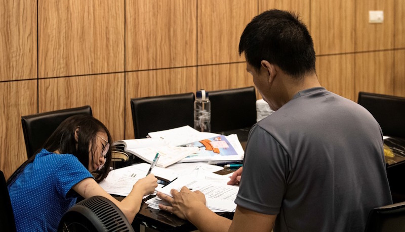 This photo taken on May 14, 2019 shows a Singaporean student studying with a tutor in her home in Singapore. Photo: Theodore Lim/AFP