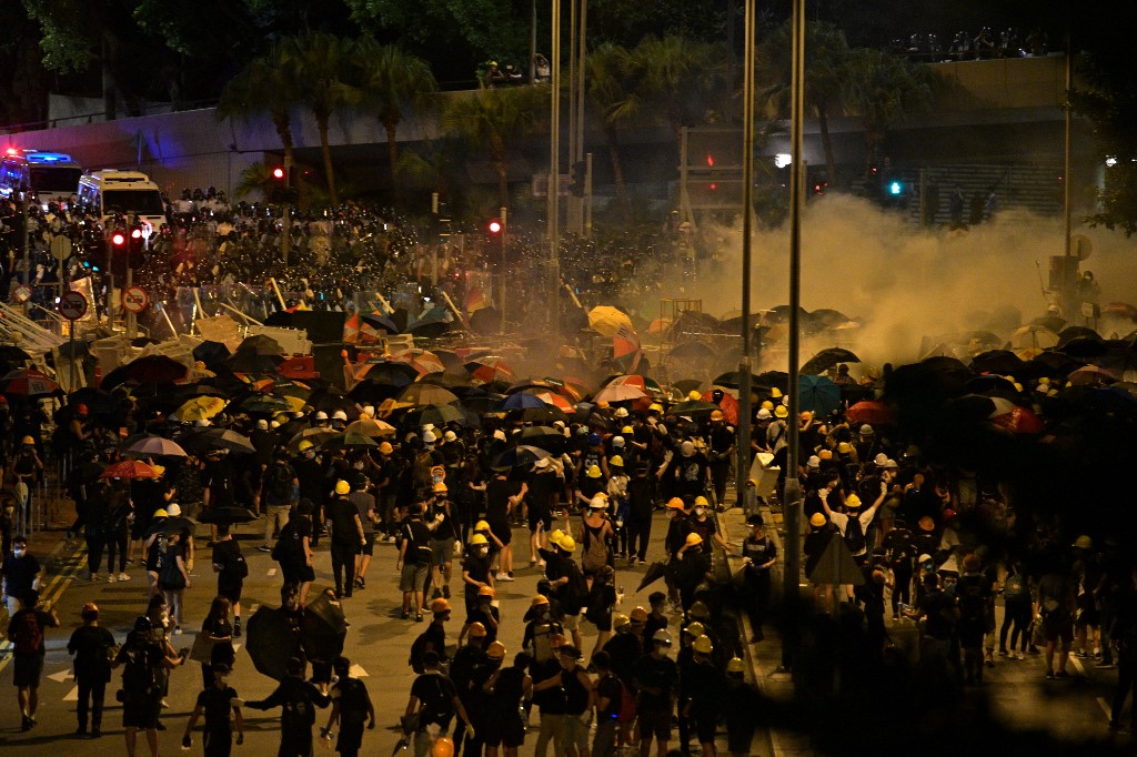 Police fire tear gas at protesters near the government headquarters in Hong Kong yesterday. Photo via AFP.