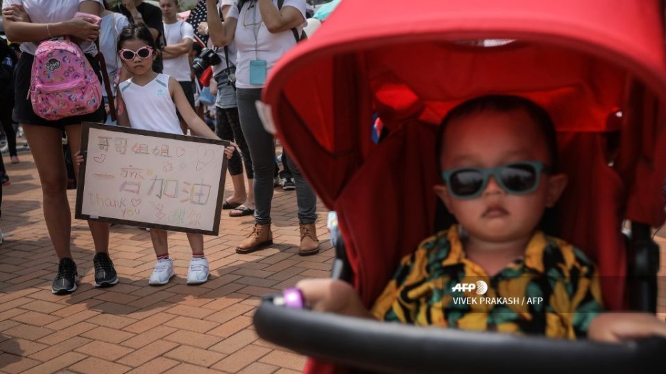 A girl holds a sign during a “guard our children’s future” event for families who are against a controversial extradition bill in Hong Kong on August 10, 2019. – Armed with balloons and strollers, several hundred families took to the streets in Hong Kong on August 10 to show support for pro-democracy protests that are now in their third month. (Photo by VIVEK PRAKASH / AFP)