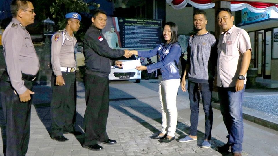 Yonita Djaralodu, center right, pose for a photo with police officers in Denpasar. Photo: Humas Polda Bali / Facebook