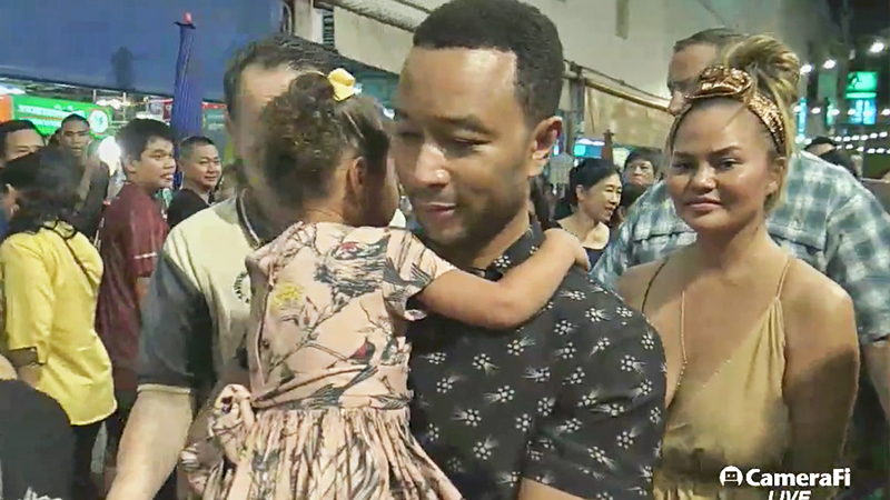 American musician John Legend and his Thai-American model wife Chrissy Teige walks through a Korat market. Photo: SaveOne Market/ Facebook