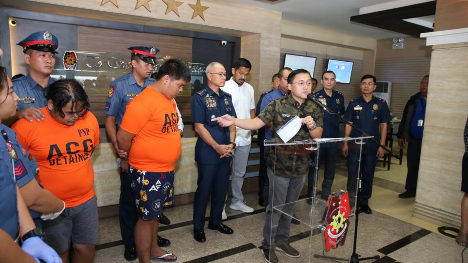 Suspects Edgar Bularan and Dennis Borbon with Senator Bong Go. <i>Photo: Philippine National Police</i> 
