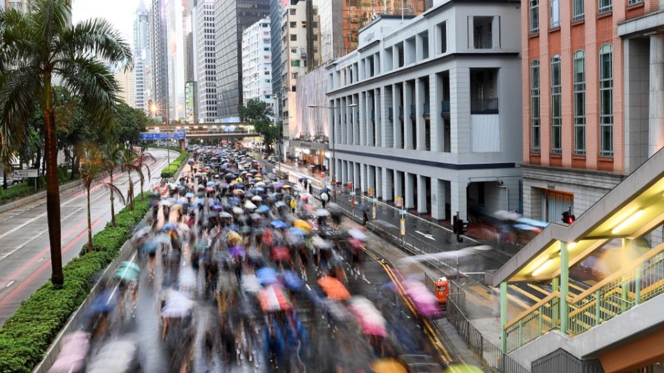 Protesters walk along a street during a rally in Hong Kong on August 18. Photo via AFP.