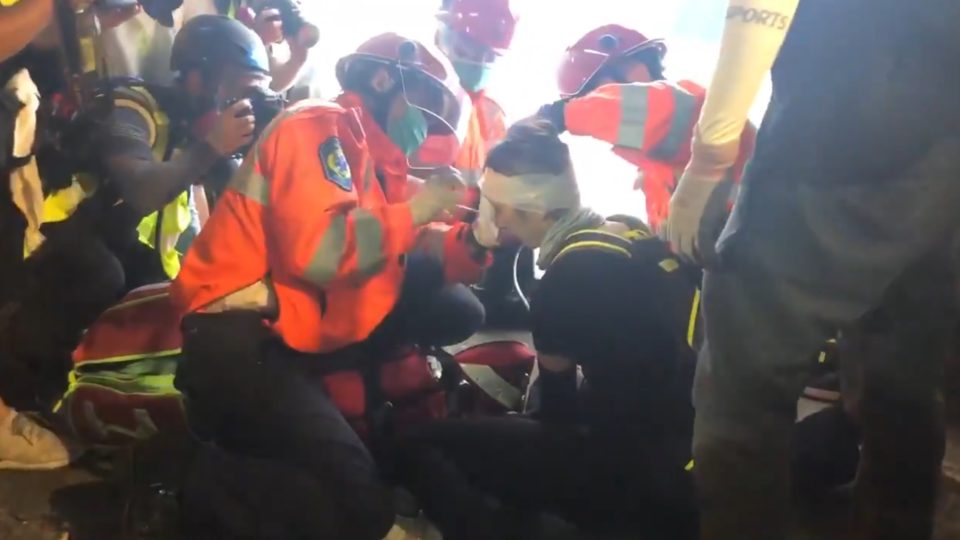 A woman shot in the eye with what was believed to be a bean bag round is treated by paramedics in Tsim Sha Tsui on Sunday evening. Screengrab via Twitter.