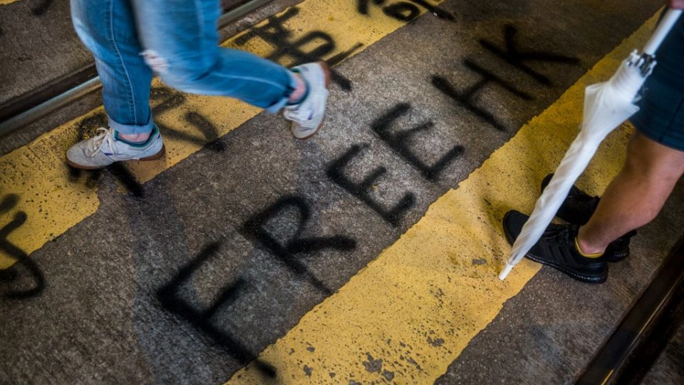 Protesters build barricades to block the road in the busy shopping district of Causeway Bay in Hong Kong on August 4, 2019, in the latest opposition to a planned extradition law that has quickly evolved into a wider movement for democratic reforms. Isaac Lawrence / AFP