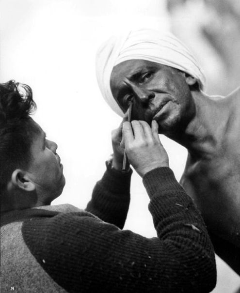 American actor Sam Jaffe has his skin darkened by a makeup artist for his role in the 1939 film 'Gunga Din.'