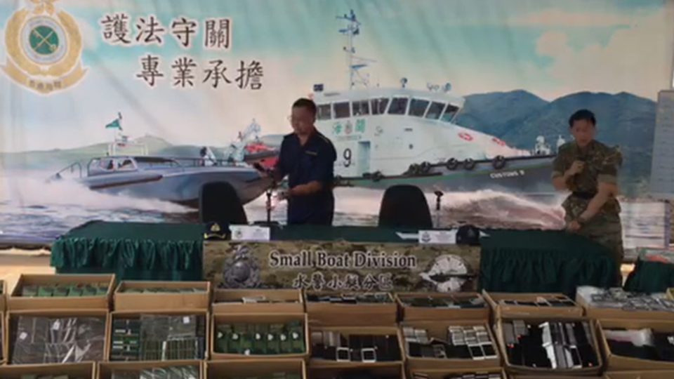 Customs and police officials show off a major smuggling bust made in the New Territories overnight. Screengrab via Facebook.