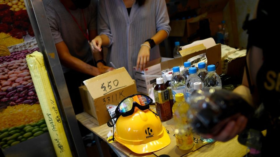 This picture taken on August 10 show pro-democracy protesters buying gas masks and other protective gear at a pop-up store in Tai Po. Photo via AFP.
