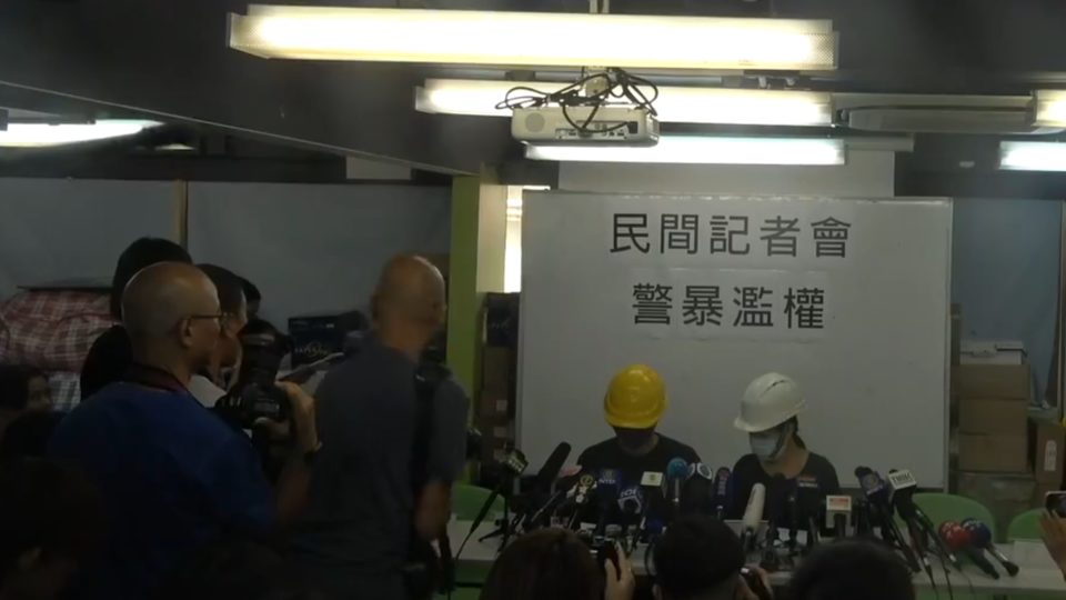 Protesters prepare to address members of the press at a briefing today. Screengrab via Facebook.