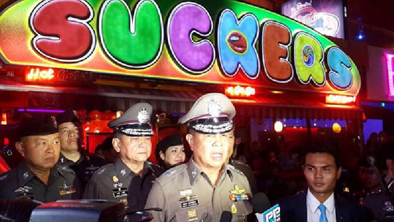Unaware of how the sign behind them would play in the English-language media, former national police chief Gen. Somyot Pumpanmuang and former police spokesman Prawuth Thawornsiri addressed reporters in front of a go-go bar days after the Aug. 17, 2015, attack to say the attacker may have left the country. Photo: Royal Thai Police